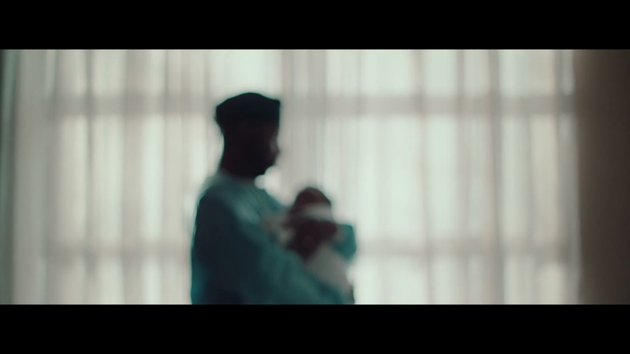 Still from Air Canada 'Ticket to Dream': a silhouetted parent holding a child behind sheer curtains in bright backlight